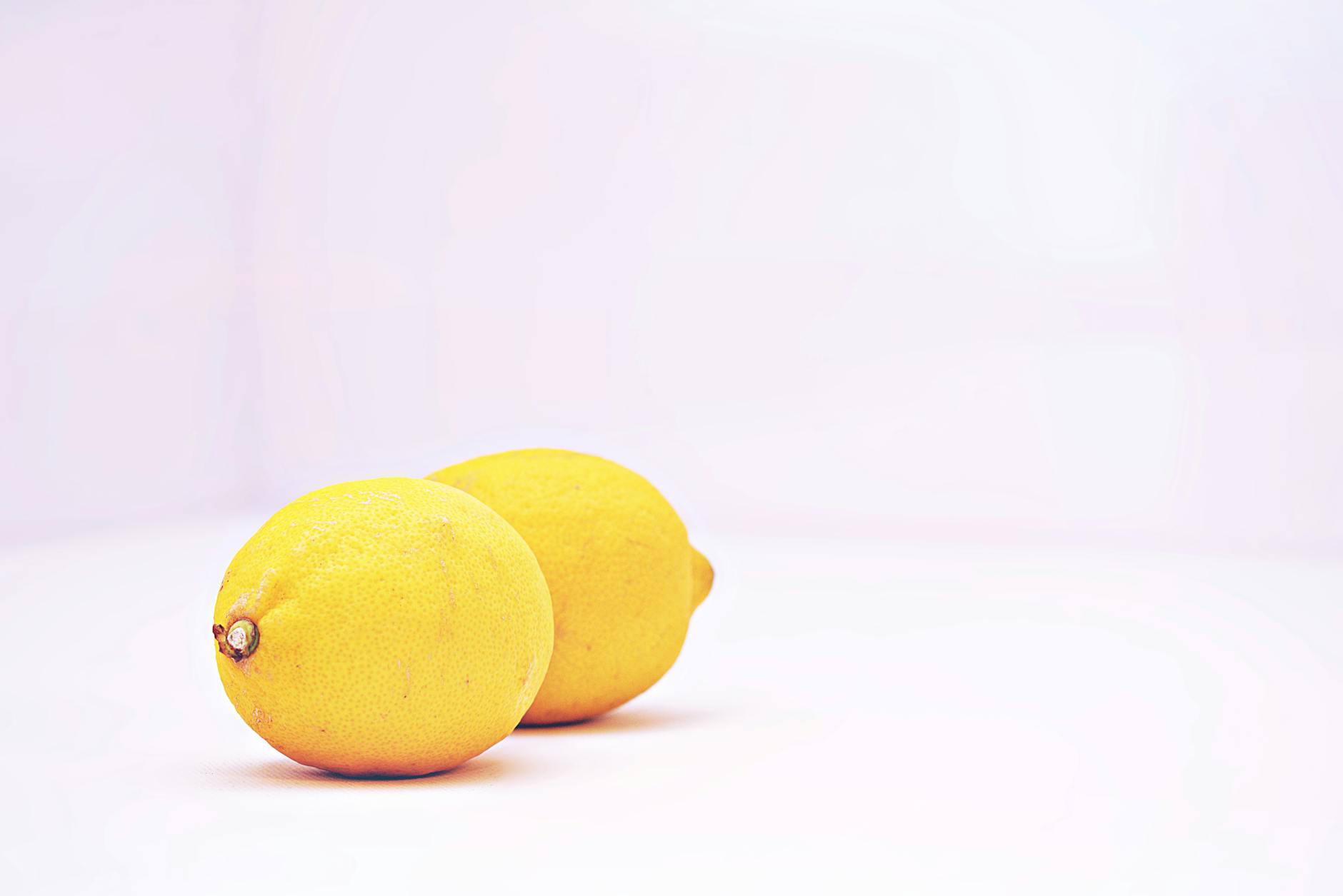 Bright lemons on a clean white background, symbolizing freshness and renewal