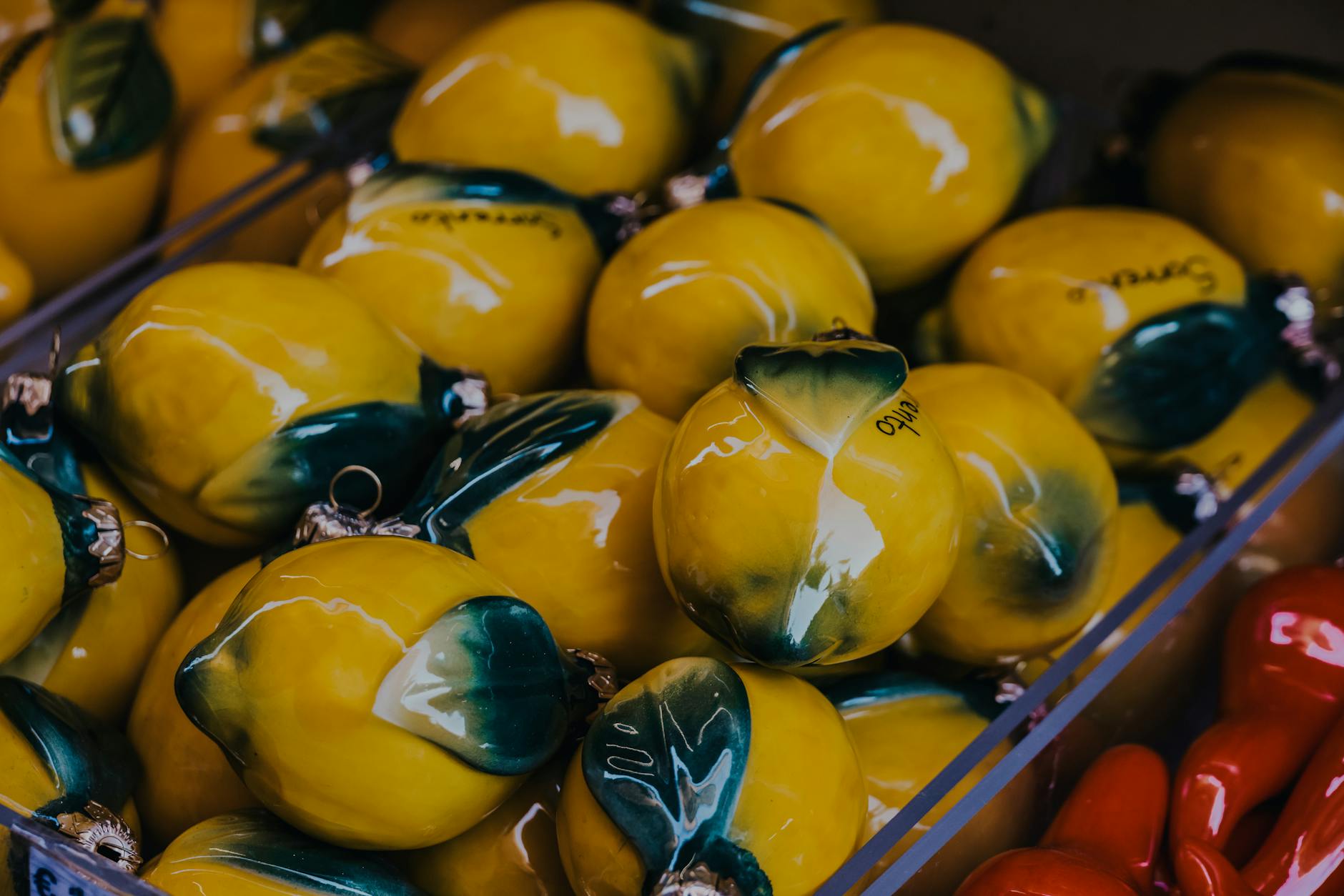 Vibrant yellow ceramic lemons arranged in bright natural light